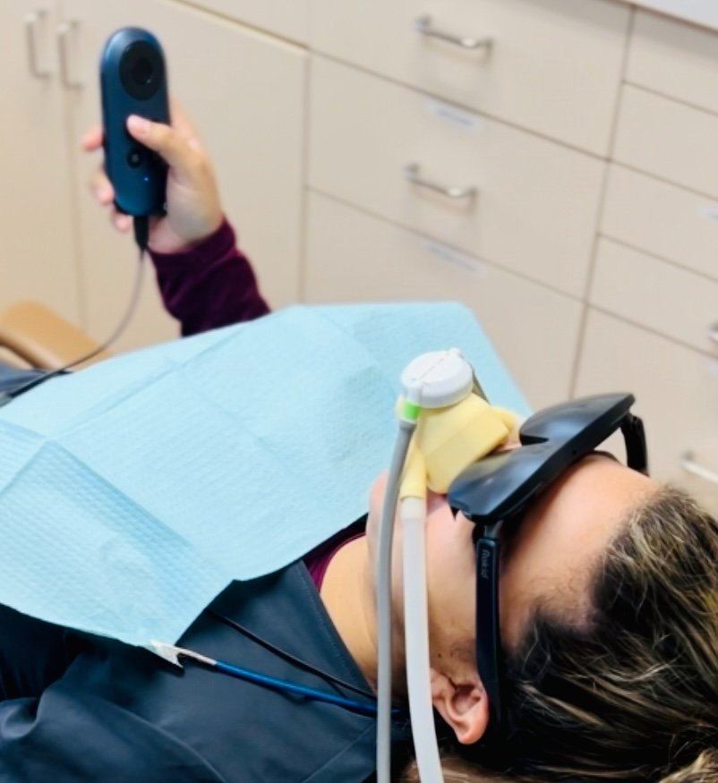 Patient relaxing with 3D video glasses and nitrous oxide during treatment